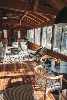 a living room filled with furniture and lots of windows