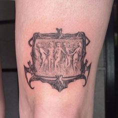 a tattoo on the leg of a woman with an image of two women in a frame