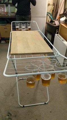 a woman standing in front of a table with four glasses on it