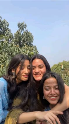 three women taking a selfie with trees in the background