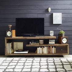 an entertainment center with bookshelves and a flat screen tv on top of it