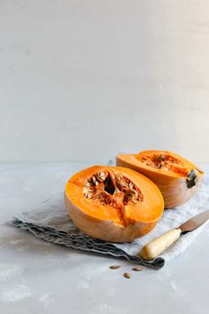 two pieces of pumpkin sitting on top of a table