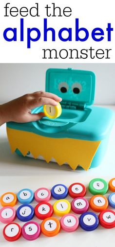 a child's hand is playing with an alphabet game and it has letters on the tray