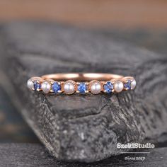 "Pearl Sapphire Wedding Band Women Rose Gold Pearl Matching Band Akoya Pearl Ring Half Eternity Stacking Minimalist Delicate Dainty Bridal Links in the same style: https://www.etsy.com/listing/1191477566/ https://www.etsy.com/listing/1394867395/ ITEM INFORMATION: Metal Type- Solid 14K White Gold *Wedding Band Details:  WIDTH-( approx. 2.0mm) Stone - Natural Akoya Pearl Size- 2mm Lab Sapphire, 1.5mm **Stone Replacement** Available with any other gemstones, please feel free to contact me for a quote. **Metal Type** Available in 14K or 18K yellow gold, white gold, and rose gold. Please select from the drop down menu. **Production Time& Rush Order** Our standard production time is 3-4 weeks from time of purchase. I am very happy to provide rush order service, the price is $60, the Process time Sapphire Pearl Engagement Ring, Adjustable Rose Gold Pearl Wedding Ring, Adjustable Rose Gold Stackable Rings For Wedding, Sapphire And Pearl Ring, Adjustable Half Eternity Stackable Rings For Wedding, Blue Minimalist Stackable Wedding Rings, Minimalist Rose Gold Pearl Wedding Ring, Minimalist Blue Stackable Wedding Rings, Adjustable Pearl Ring For Wedding