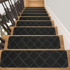 three black rugs are on the stairs