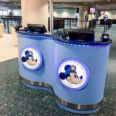 an airport check in counter with mickey mouse stickers on it