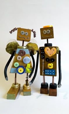 two toy robots are standing next to each other