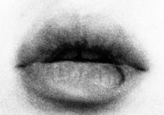 a black and white photo of the lip of a woman's mouth with it's tongue sticking out