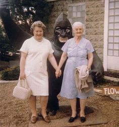 two women standing next to each other holding hands