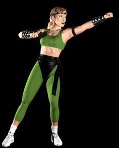 a woman in a green top and black leggings doing a kickbox pose