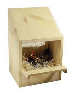 a wooden bird house with two chickens inside