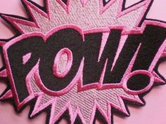 a pink and black patch with the word roll on it