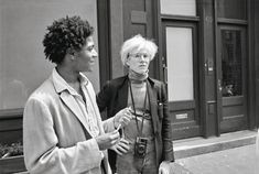 two women standing on the sidewalk talking to each other