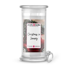 a glass jar with a christmas in memory label on it and a ring next to it