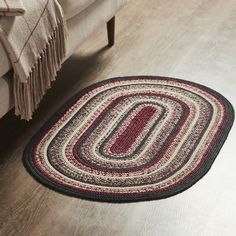 a living room area with a couch and rug on the floor in front of it