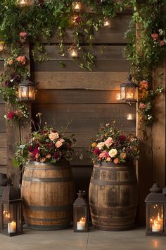 two wooden barrels with flowers and candles on them