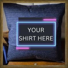 a blue pillow with a neon sign on it that says your shirt here in front of a gold frame