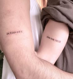 two people holding each other with tattoos on their arms that say, in this life and the next