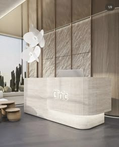 an office lobby with a reception desk and chairs in front of a large window that reads clinic