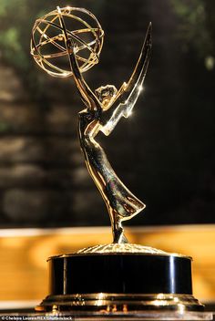 an award statue is shown in front of a blurry background