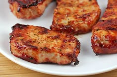 grilled pork chops on a white plate