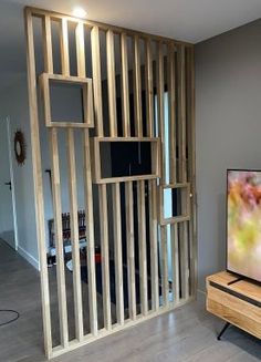 a flat screen tv sitting on top of a wooden stand in front of a wall