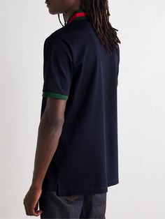 Gucci's polo shirt is a refined take on a preppy staple. It's made from stretch-cotton piqué and detailed with signature green and red stripes at the collar. The chest pocket is discreetly embroidered with the label's monogram. Large to size. See Size & Fit notes. Gucci Cotton Short Sleeve Polo Shirt, Gucci Cotton Polo Shirt, Gucci Casual Collared Polo Shirt, Casual Gucci Polo Shirt, Casual Gucci Collared Polo Shirt, Casual Gucci Cotton Polo Shirt, Classic Gucci Cotton Polo Shirt, Casual Gucci Tops For Work, Gucci Cotton Collared Polo Shirt