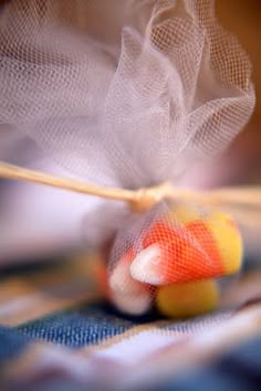 a close up of an object on a table with blurry images in the background