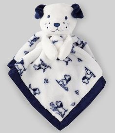 a white and blue teddy bear on a blanket