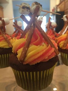 some cupcakes with sticks sticking out of them