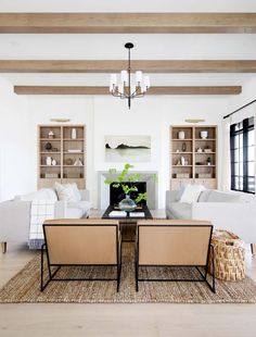 a living room with two couches and a coffee table in front of a fireplace