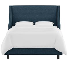 a bed with white sheets and blue headboard on it's side, in front of a white background