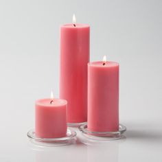 three pink candles sitting next to each other