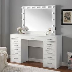 a white vanity with lights on it in a room