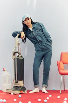 a woman standing next to a vacuum cleaner