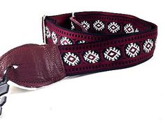 a red belt with white and black designs on it, next to a pair of scissors