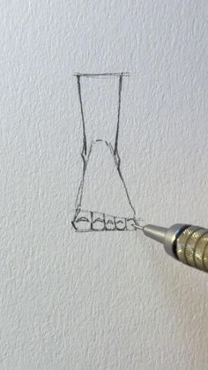 a drawing of a dress hanging on a wall with a pen in the foreground