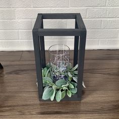 a candle holder with some plants in it