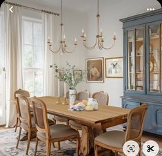 a dining room table with chairs and a china cabinet