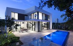 a modern house with a swimming pool in the backyard