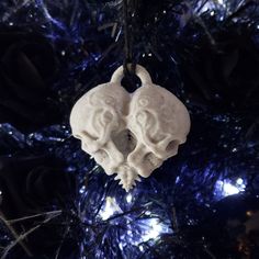 a white ornament hanging from a christmas tree