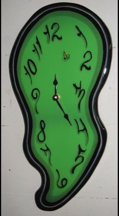 a green clock with black numbers on it