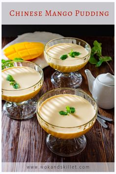 three glasses filled with pudding sitting on top of a wooden table