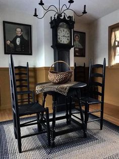 a table with chairs and a clock on the wall in a dining room area,