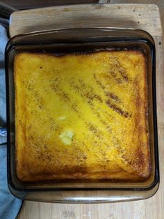 a square cake sitting on top of a wooden cutting board