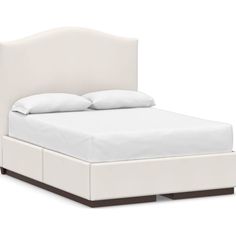 a bed with white sheets and pillows on top of the headboard, in front of a white background