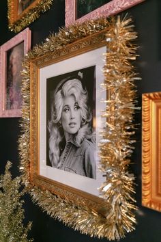 there are pictures on the wall with tinsel