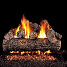 a fire is burning in the fireplace with logs and flames on it's sides