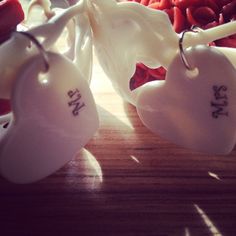 two ceramic hearts with the word love spelled on them