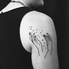 two hands holding stars tattoo on the left arm